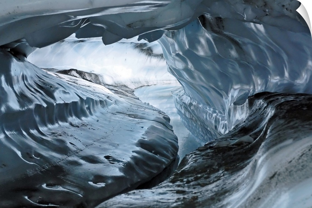 A photograph inside a tunnel that was formed by a water channel inside a glacier.