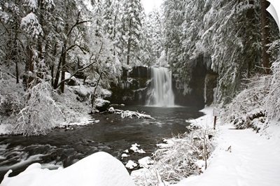 A Waterfall In To A River In Winter
