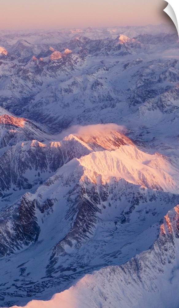 Aerial view of the Chugach Mountain range with sunrise alpenglow hitting the peaks during Winter in Southcentral Alaska