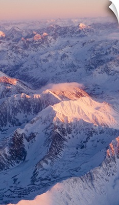 Aerial view of the Chugach Mountain range with sunrise alpenglow hitting the peaks