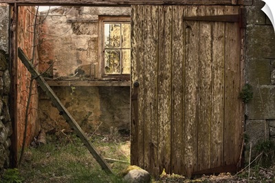An Abandoned Building In Ruins With A Broken Wooden Door, Northumberland, England