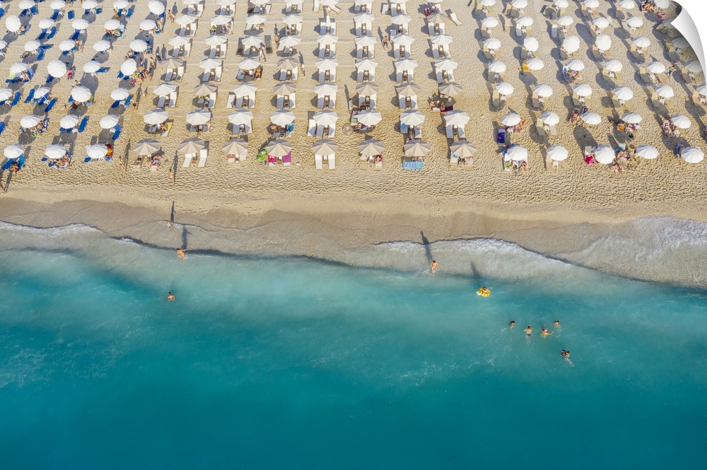 An aerial view of Kathisma beach in Lefkada with people enjoying the deep blue waters.