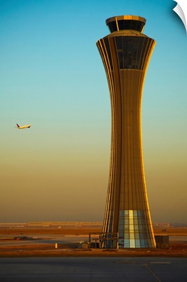 An Airplane Flies Past The Air Traffic Control Tower At The Beijing Airport, China