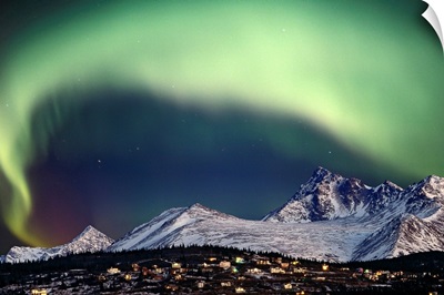 Aurora Borealis over hillside neighborhood & Chugach Mountains Anchorage Alaska