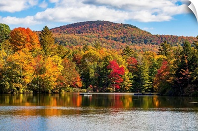 Autumn coloured trees in a forest around a small lake, Sally's Pond, Quebec, Canada