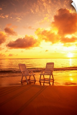 Beach Chairs Along Shoreline At Sunset