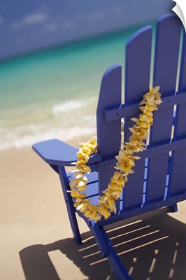 Blue Beach Chair With Plumeria Lei Hanging On Side