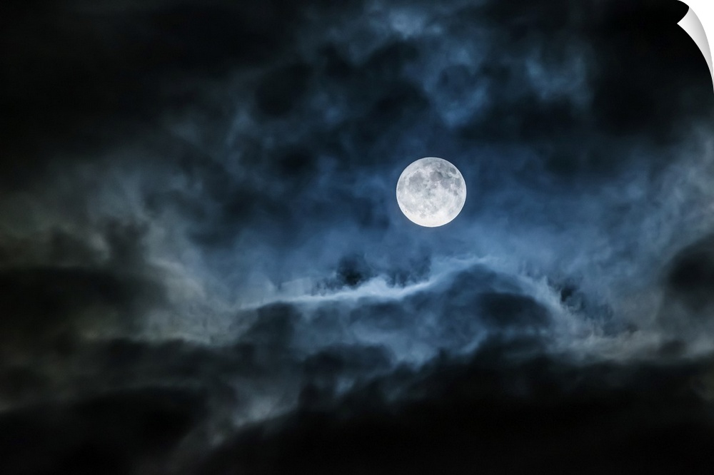 Bright full moon glowing in a cloudy sky; Ontario, Canada