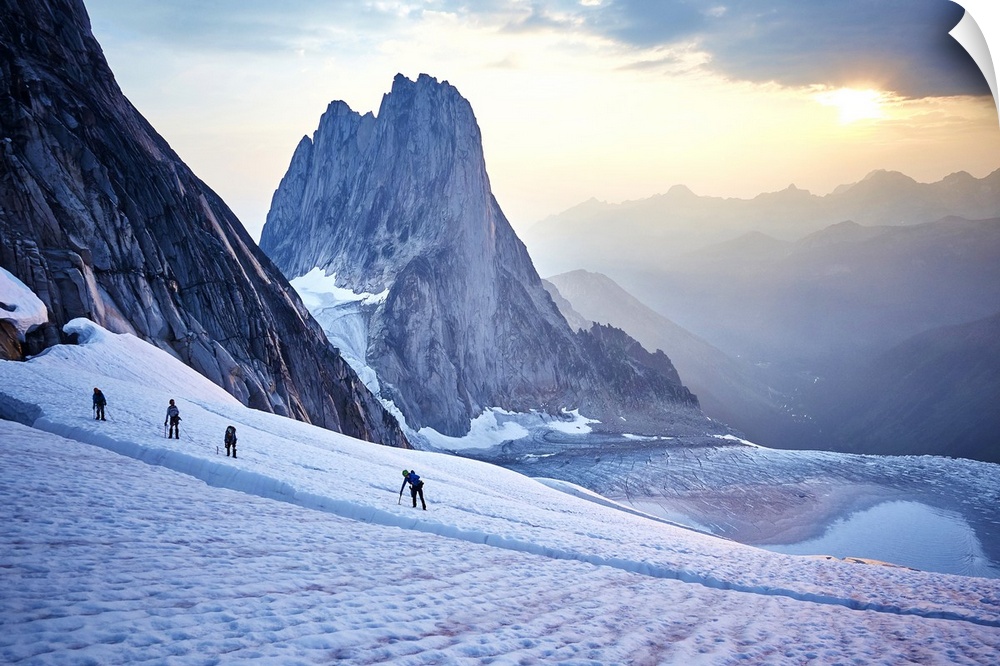 Hiking around a crevice of West Ridge of Pigeon Spire route in the Bugaboos Provincial Park at dawn. British Columbia, Can...