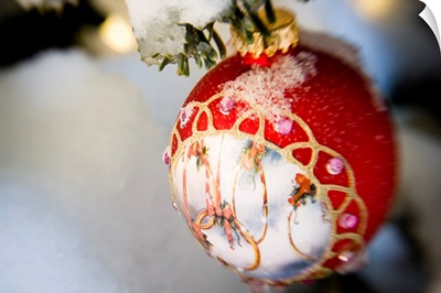Close up of a Christmas ornament hanging on a snowcovered branch outdoors during winter