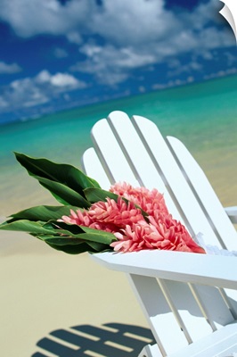 Close-Up Of White Beach Chair With Bunch Of Pink Ginger, On White Sand