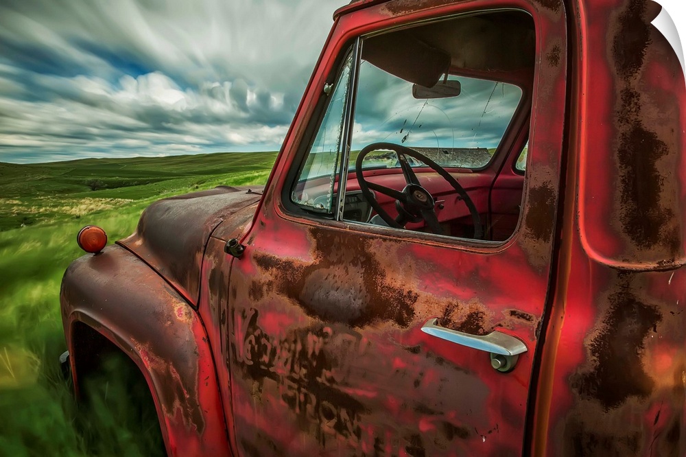 Long exposure of clouds drifting by over an abandoned truck in a rural area, Saskatchewan, Canada.
