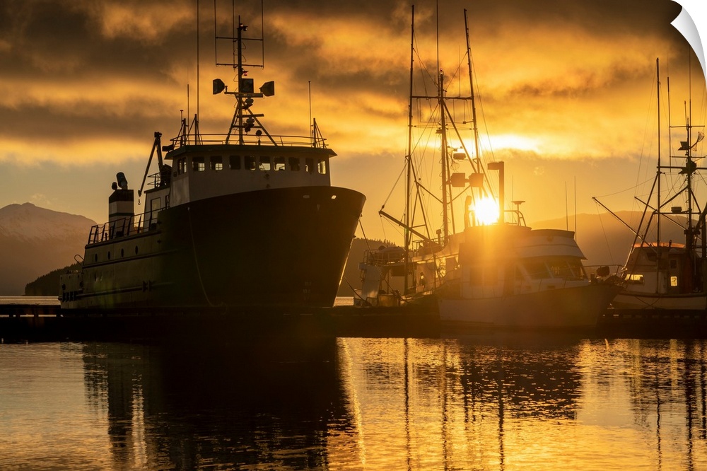 Commercial fishing boats in Auke Bay at sunset, Southeast Alaska; Juneau, Alaska, United States of America.