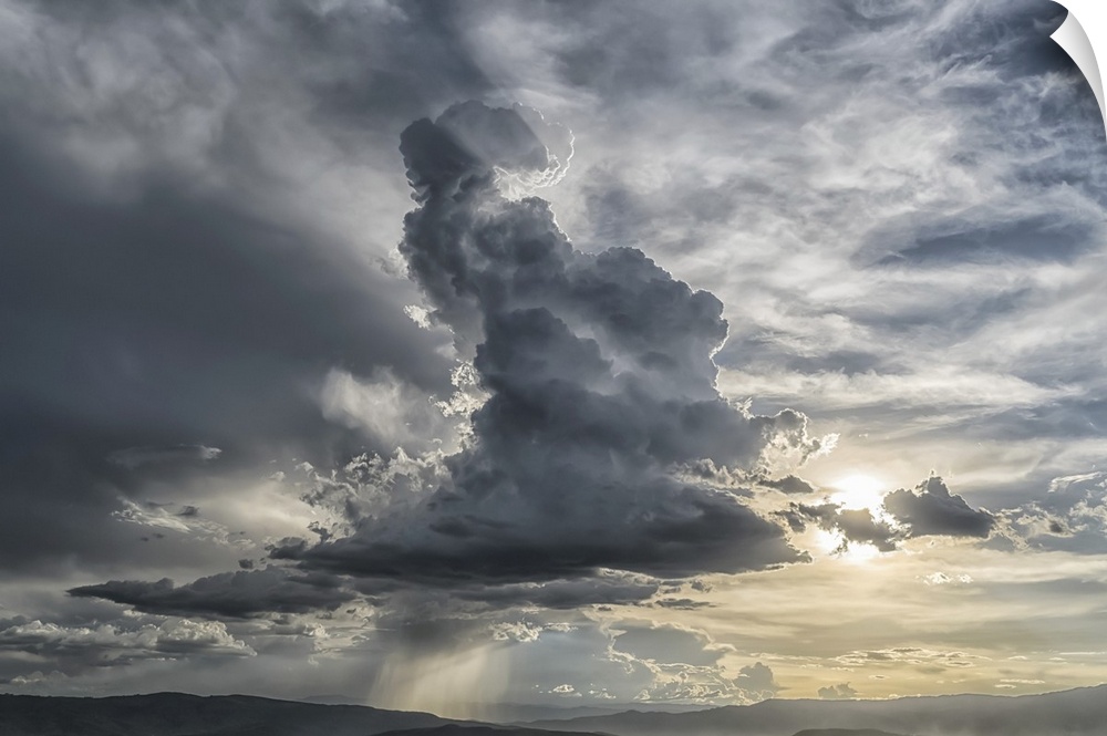 Cumulonimbus cloud building over the city of Cochabamba, Bolivia. Inspirational lighting coming from behind the cloud, Coc...