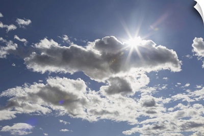 Cumulus Clouds In A Blue Sky With Sunlight Bursting Behind, Edmonton, Alberta, Canada