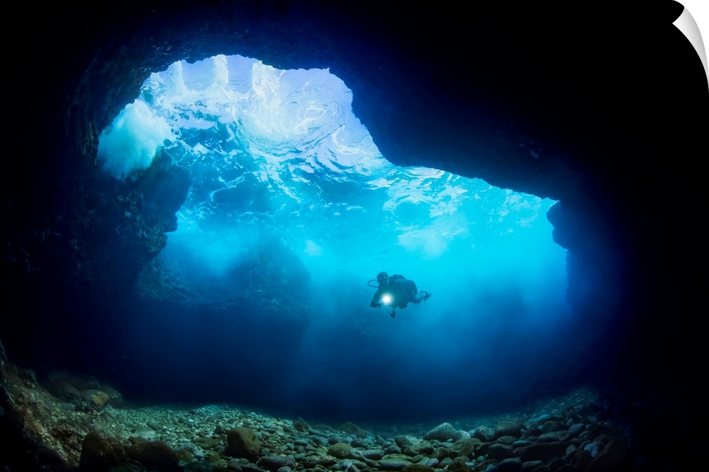 Diver inside a shallow tide pool canyon off the backside of Lanai near Kaumalapau Harbor; Lanai, Hawaii United States of A...