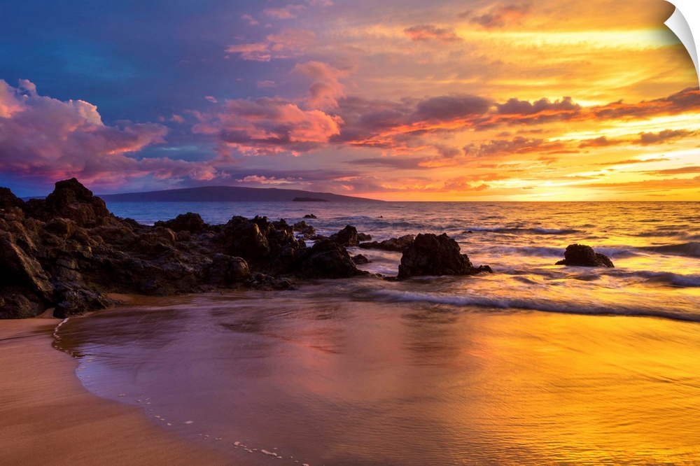 Dramatic clouds during a sunset on a beach; Makena, Maui, Hawaii, United States of America.