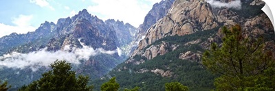 Dramatic mountain landscape fringed by forest, Corsica