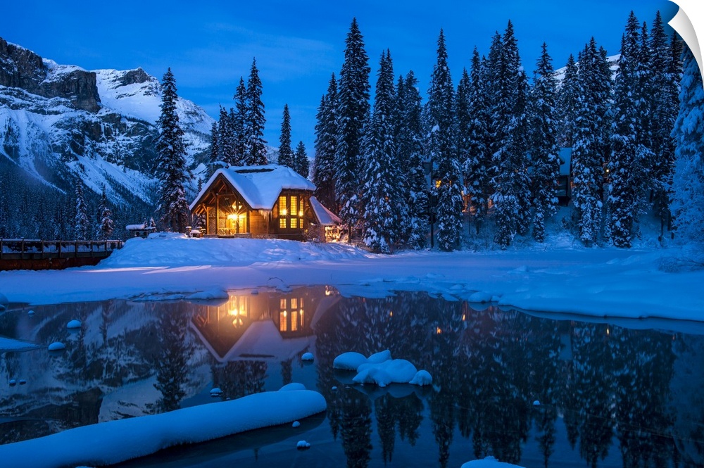 Emerald Lake Lodge on Emerald Lake backed by President range at night in the Canadian Rockies.