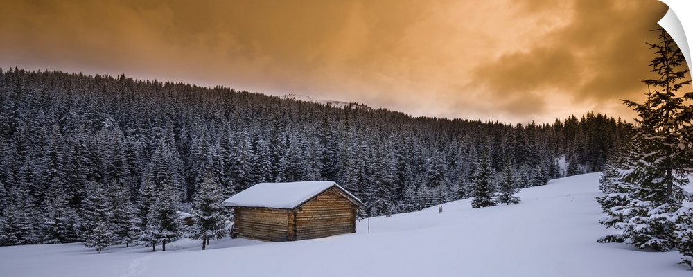 Farm hut and forest in winter, dolomite mountains, Alta Badia, south Tyrol, Italy.