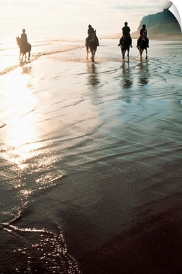Four People Horseback Riding On A Coastal Beach, Ireland