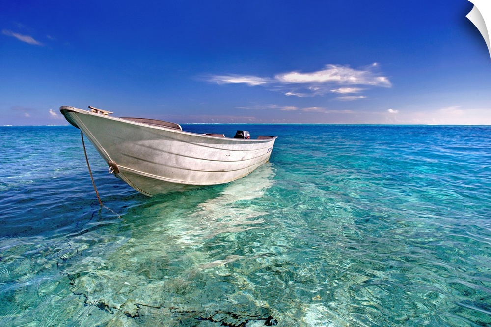 An image print of a wooden boat floating in a crystal clear ocean.
