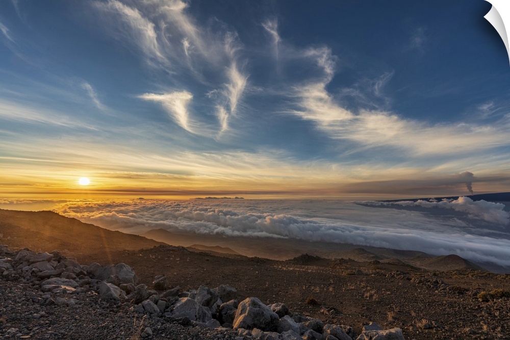 Spectacular scene of the golden twilight above the clouds at Mauna Kea with view of the smoke from 2022 eruption of Mauna ...