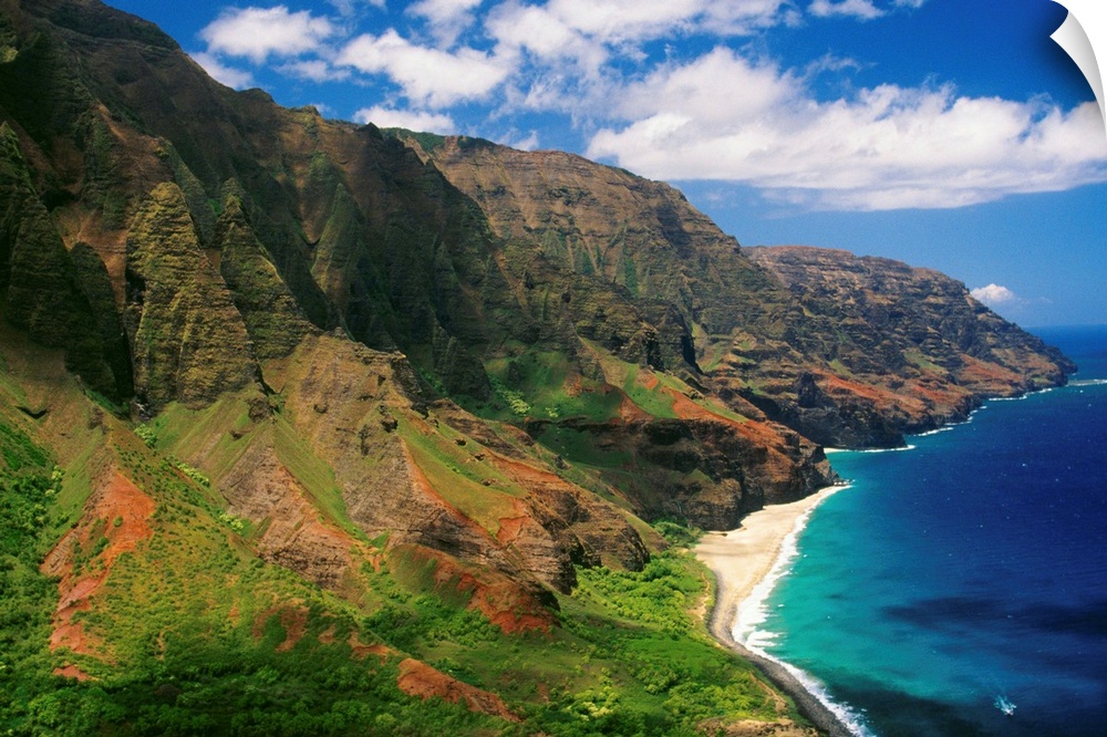 Immense cliffs that line the Hawaiian coast are photographed on a bright sunny day.