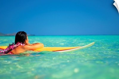 Hawaii, Oahu, Lanikai, Woman Resting On Surfboard Looking Out On Clear Teal Water