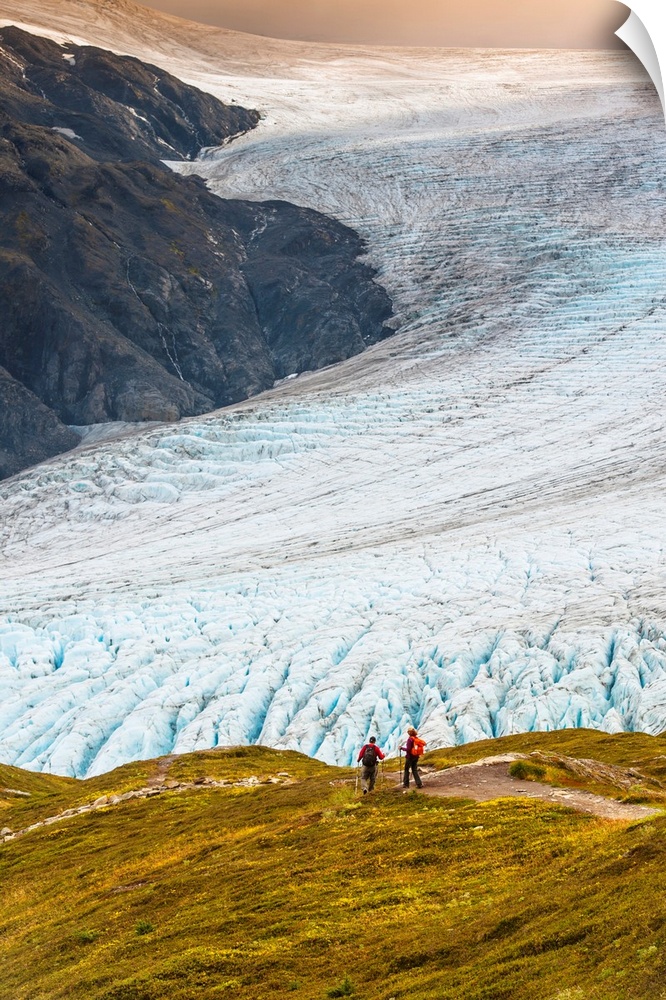 A man and woman hiking down the Harding Icefield Trail with Exit Glacier in the background, Kenai Fjords National Park, Ke...