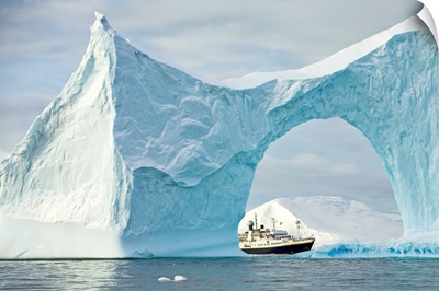 Iceberg With Arch Frames An Expedition Ship, Yalour Islands, Antarctica