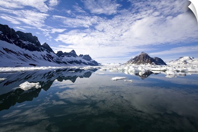 Jagged Coastal Peaks Casting Reflections In Cold Arctic Waters