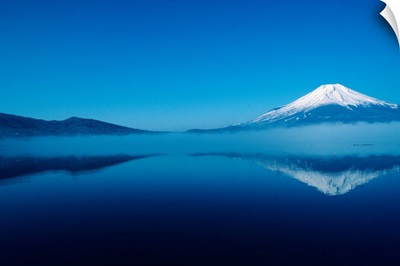 Japan, Mount Fuji, Lake Motosu, misty reflection of snowcapped mountain