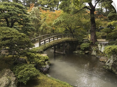 Japanese Stone Bridge Across A Stream In A Park, Kyoto, Japan
