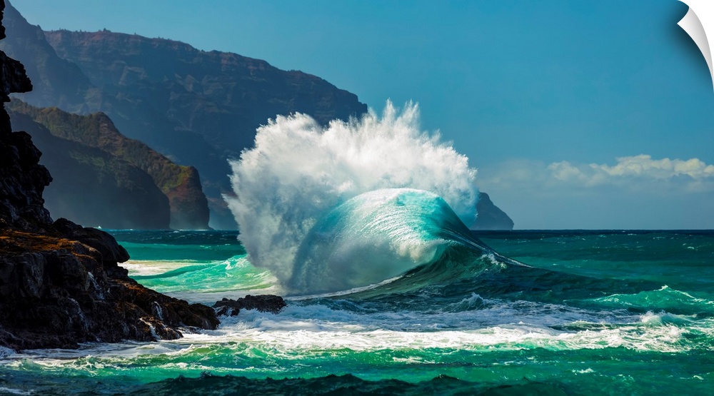 Large ocean wave crashes into rock along the Na Pali coast, Kauai, Hawaii, united states of America.