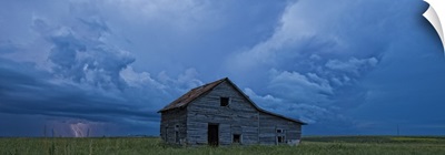Lightning strikes over the prairies and abandoned farm house, Val Marie, Saskatchewan