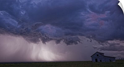 Lightning strikes over the prairies  and abandoned farm house, Val Marie, Saskatchewan