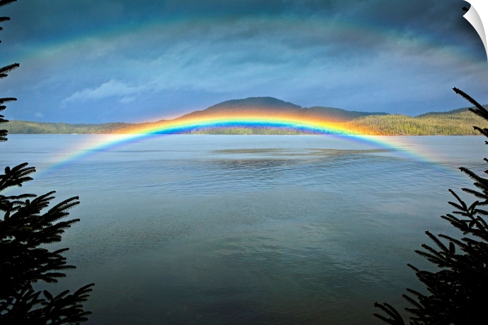 Large landscape photograph of a rainbow over the rippling  waters of Clover Passage, in Ketchikan, Southeast Alaska in ear...