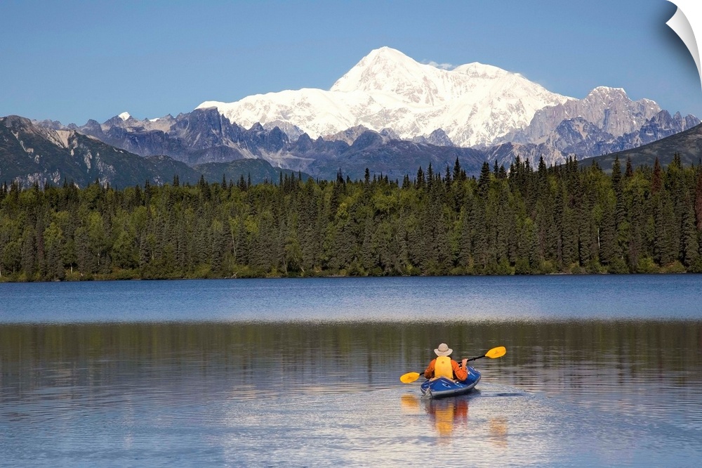 A man paddles a Klepper kayak on Byers Lake, Denali State Park, Alaska. Mt. McKinley is in the background. August.