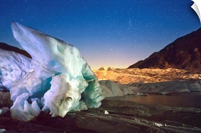 Mendenhall Glacier with a large iceberg and starry sky, Juneau, Southeast Alaska