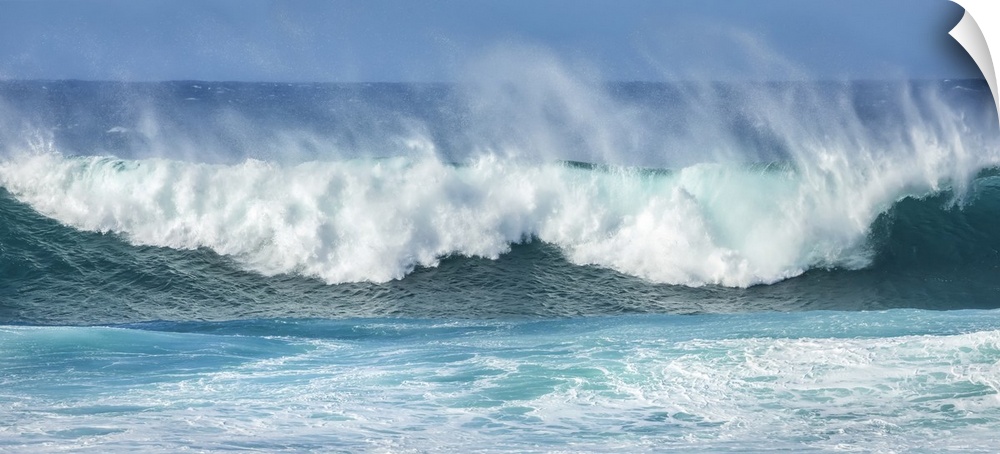 Mist rising off crashing blue waves at the shore; Kihei, Maui, Hawaii, United States of America.
