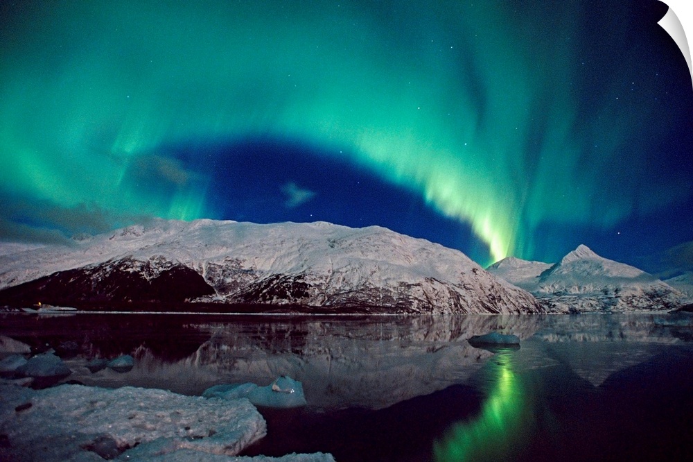 Canvas photo art of northern lights in the sky above snow covered mountains near water.