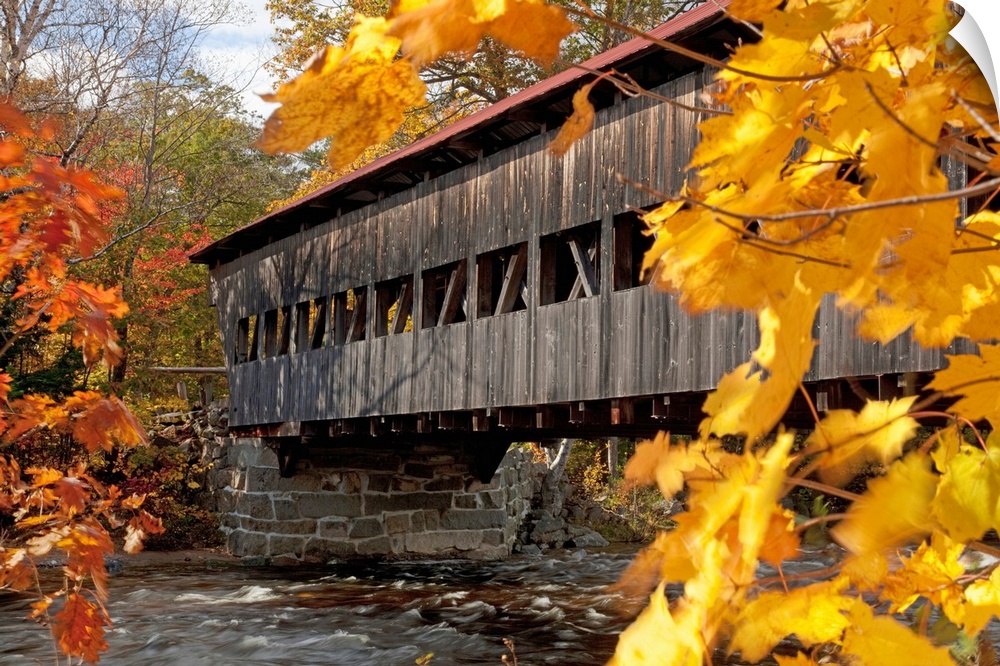 New England, New Hampshire, White Mountains, A Covered Bridge Over A River In Autumn