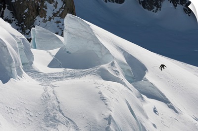 Professional snowboarder jumps off a glacier, New Zealand