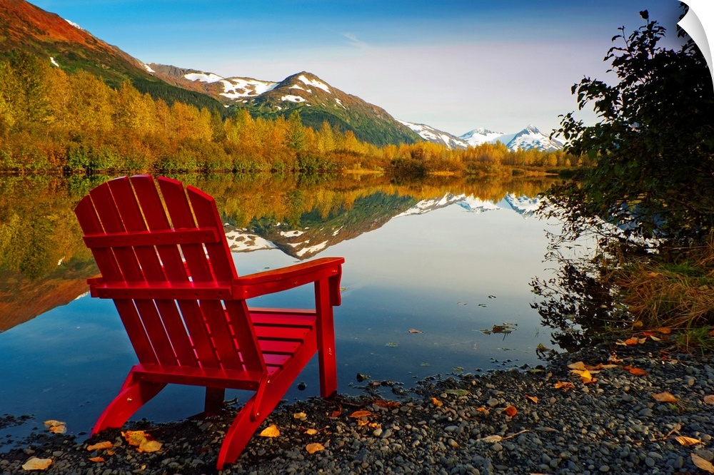 Landscape photograph on a big canvas of a red Adirondack chair sitting at the edge of a lake that is surrounded by trees. ...