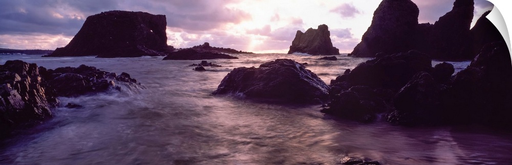 Rocks in the sea at sunset, Whiterocks, Co Antrim, Ireland.
