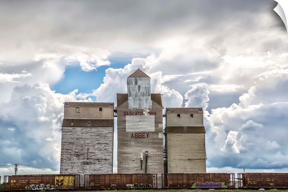 Rural grain elevator with cumulonimbus clouds building up around it, Saskatchewan, Canada.