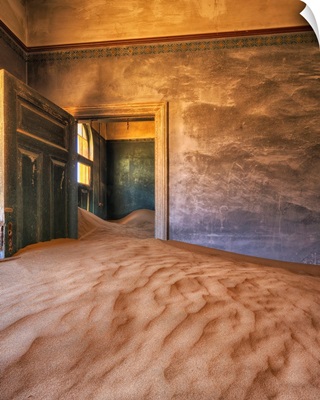 Sand in the rooms of a colourful and abandoned house, Kolmanskop, Namibia