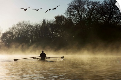 Sculling in mist on River Thames, London, England