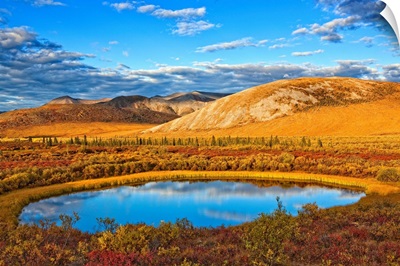 Setting Sun Illuminates The Tundra And A Pond Along Dempster Highway, Yukon